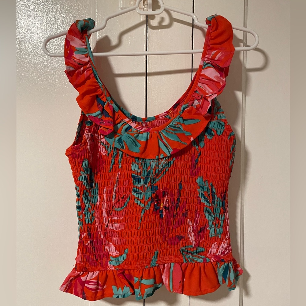 Smocked tank top with frills on sleeves and waist.